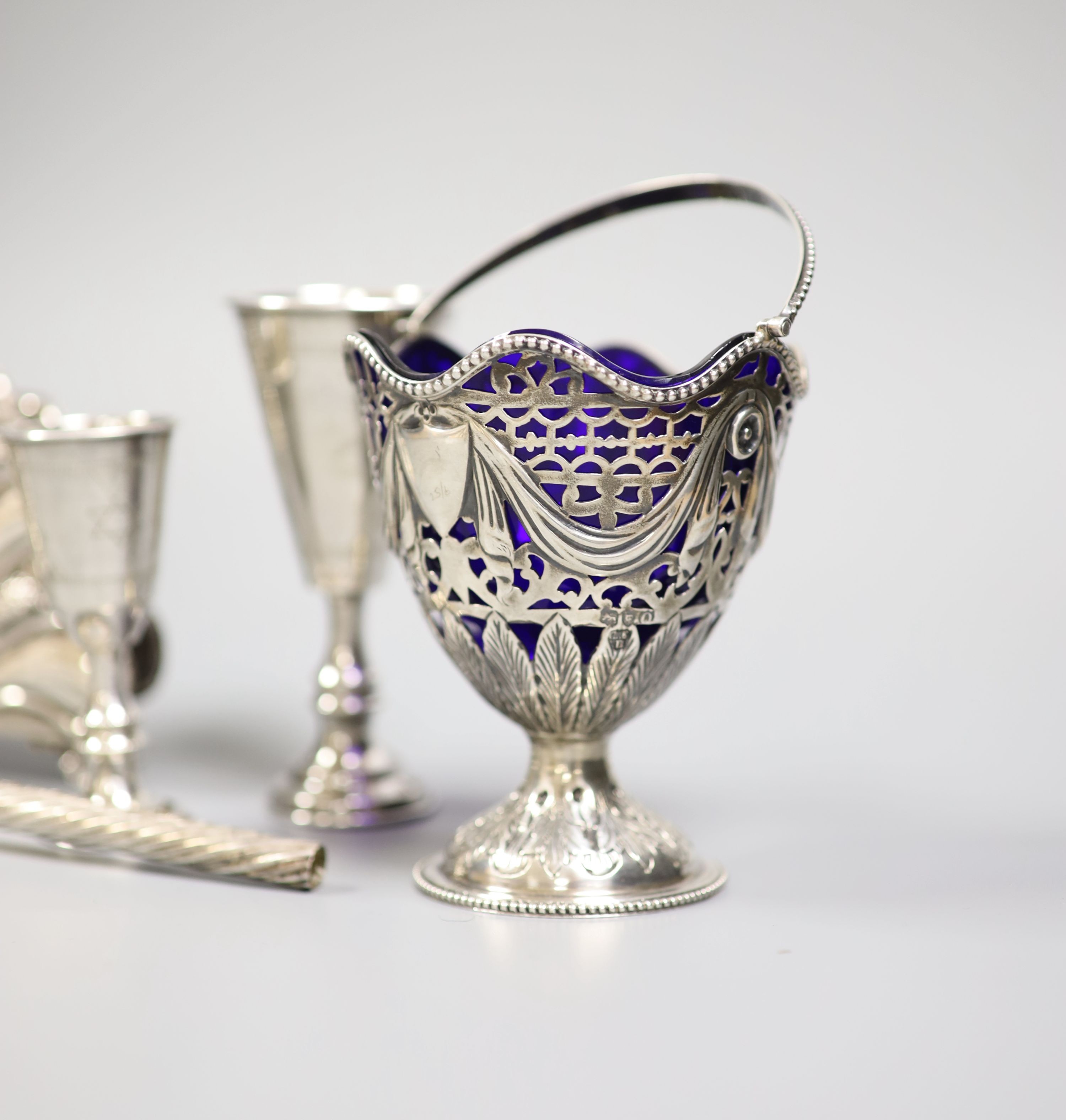 Four George V silver kiddush cups, largest 10.9cm, two other Judaic items, a 925 letter rack, silver napkin ring and Edwardian silver sugar basket.